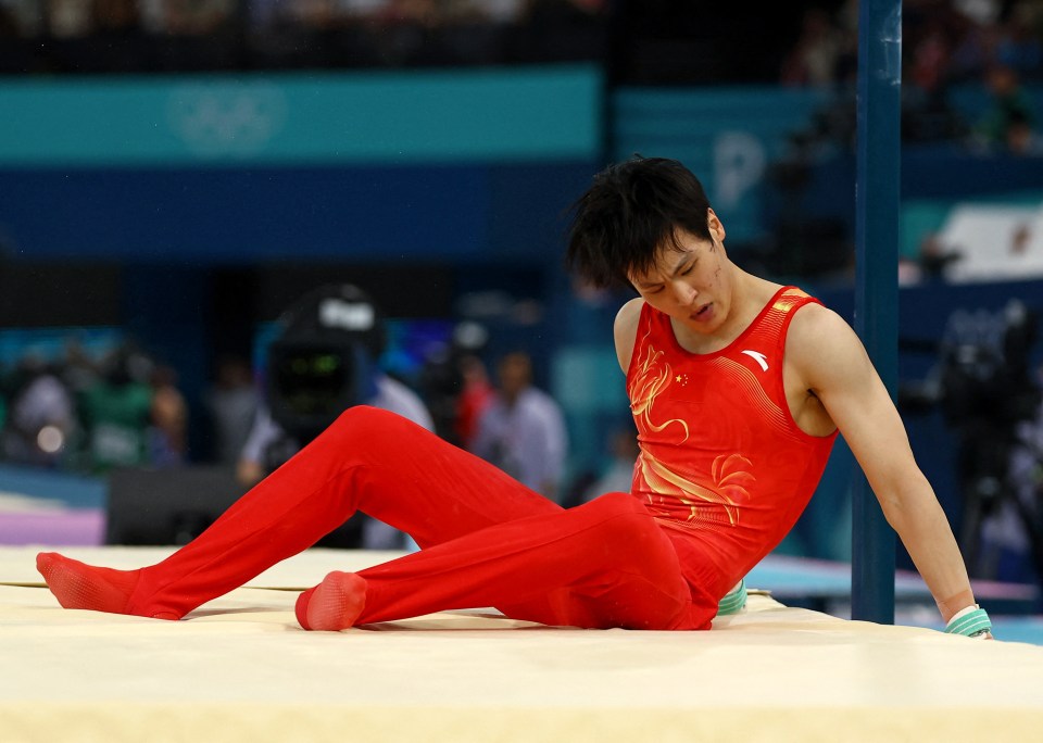 a man in a red leotard with the letter p on it