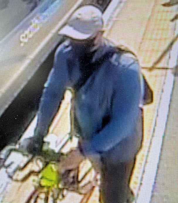 The masked suspect with a bike at a train station in 2024