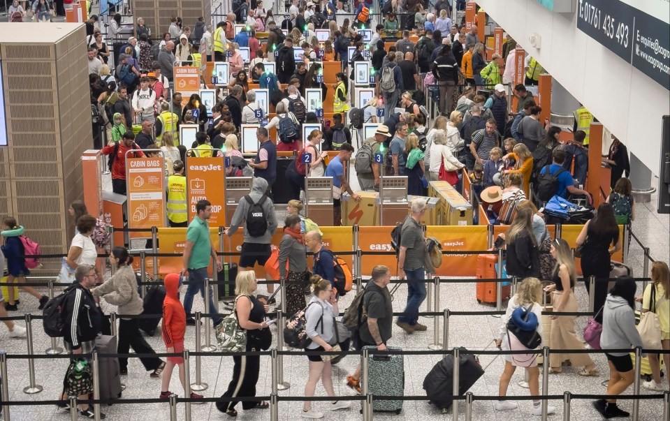 a large group of people are waiting at a check in counter for easyjet