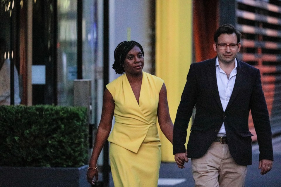 2JH6R8T London, UK. 15th July, 2022. Kemi Badenoch leaves the studios with her husband Hamish Badenoch. Leadership candidates and their teams depart the BT studios in Stratford. All five Conservative Party Leadership Candidates, (Kemi Badenoch, Penny Mordaunt, Rishi Sunak, Liz Truss and Tom Tugendhat) and candidates to become the next Prime Minister of the UK take part in a debate and q&a for Channel 4. Credit: Imageplotter/Alamy Live News