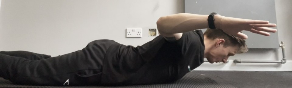 Lie on your front and squeeze your shoulder blades together to lift your bent arms