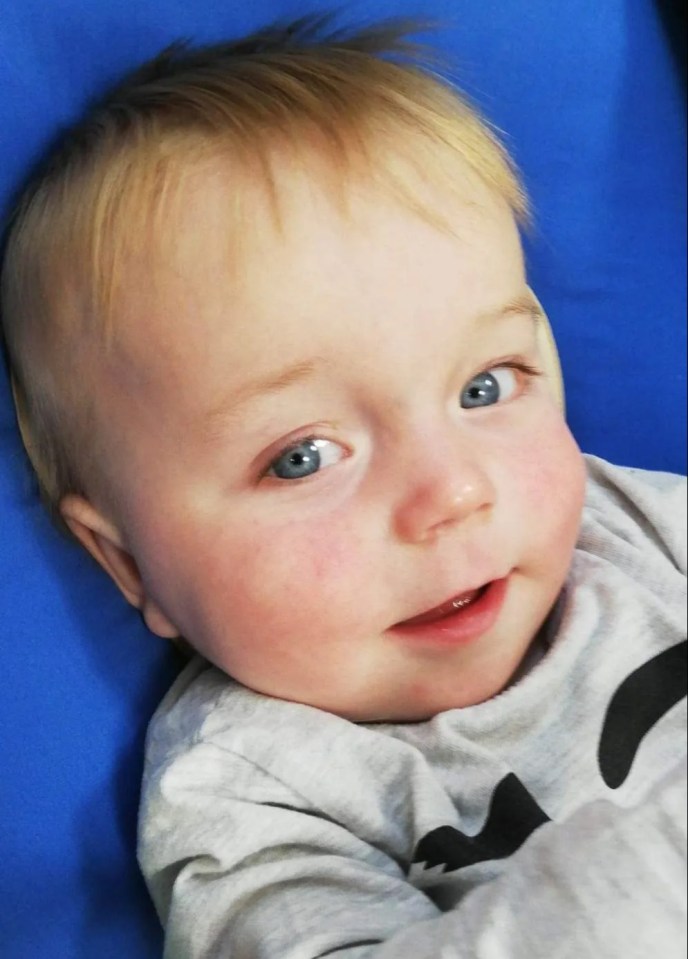 a close up of a baby laying on a blue blanket