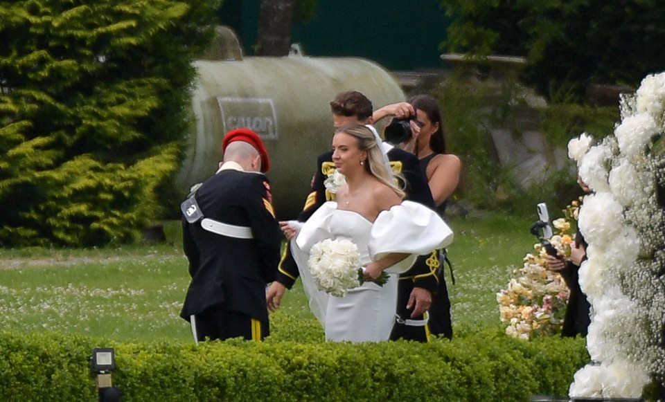 a woman in a white dress stands in front of a sign that says chloe