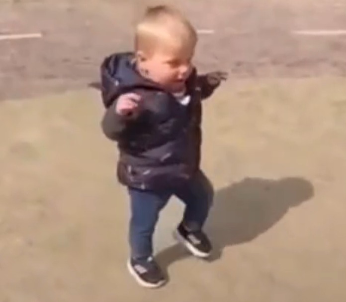 a little boy is dancing in a playground .