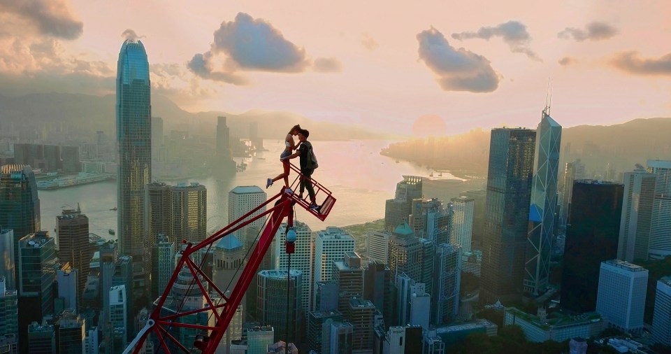 Daredevils Angela Nikolau and Ivan Beerkus embrace on top of a crane in Hong Kong