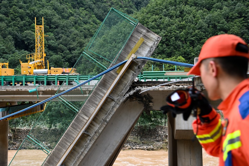 Part of the bridge that snapped and fell into floodwater