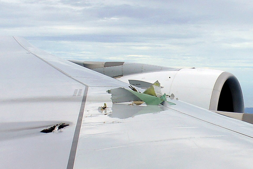 a close up of an airplane wing with a hole in it