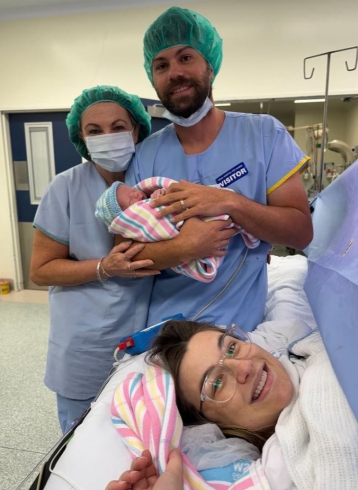 Kirsty in bed and mum Michelle and Nick holding baby Henry