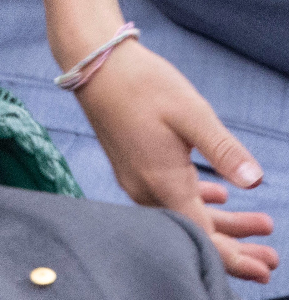 She appeared to wear one pink band, and another with green and pink thread