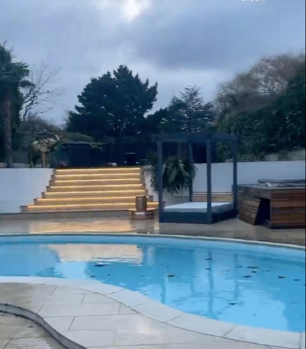 Joey's pool is entered through a grande staircase