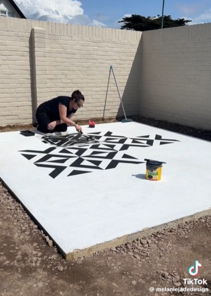 She then used black paint and a stencil to give the patio its design