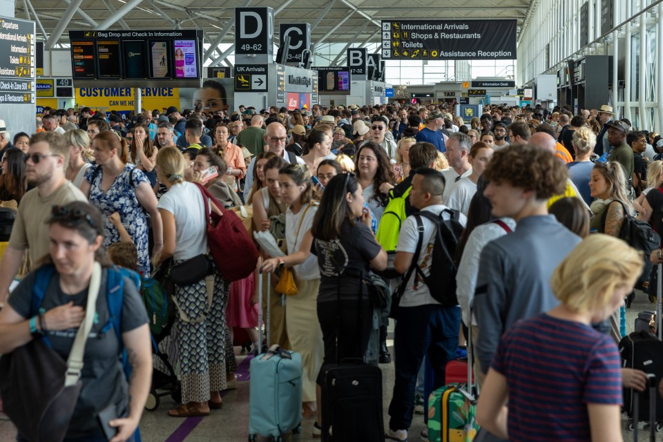 a crowd of people at an airport with a sign that says customer service