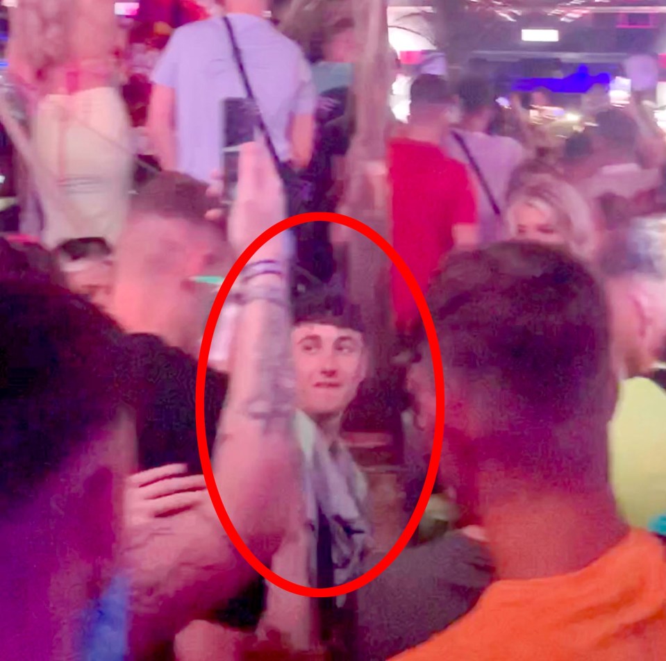 a man in a crowd with a red circle around his face