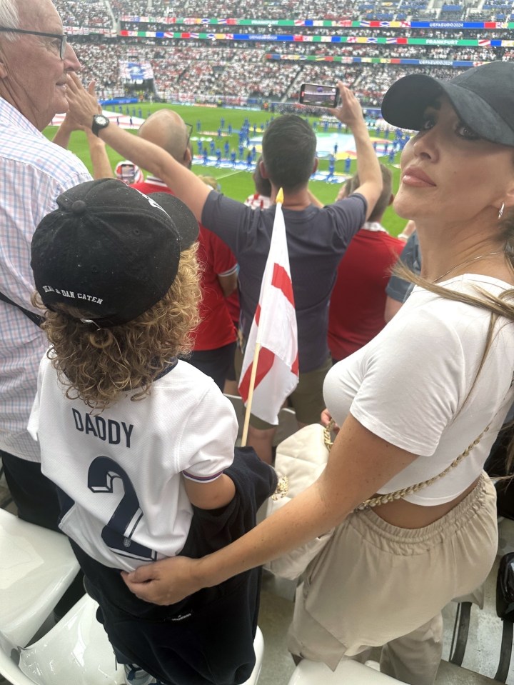 EXCLUSIVE: PREMIUM EXCLUSIVE RATES APPLY:..Lauryn Goodman Watches Kyle Walker Play For England v Denmark In Frankfurt With Her Son Kairo..Fans inside the stadium captured mobile phone pics of Kairo, whose father is Walker, cheering on the England defender at Deutsche Bank Park stadium..Kairo wore an England shirt with 'Daddy' and number two on the back and waved an England flag..Lauryn, who sported a baseball cap, was also accompanied to the game by her grandfather, John..Adorable Kairo received lots of attention at the game, including a Danish fan who said hello as they walked to the stadium...Pictured: kairo walker,lauryn goodman.Ref: BLU_S7763516 200624 EXCLUSIVE.Picture by: / SplashNews.com..Splash News and Pictures.USA: 310-525-5808 .UK: 020 8126 1009.eamteam@shutterstock.com..World Rights