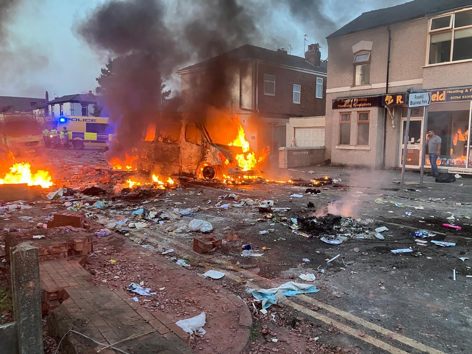 Police vans were set ablaze during chaotic scenes in Southport