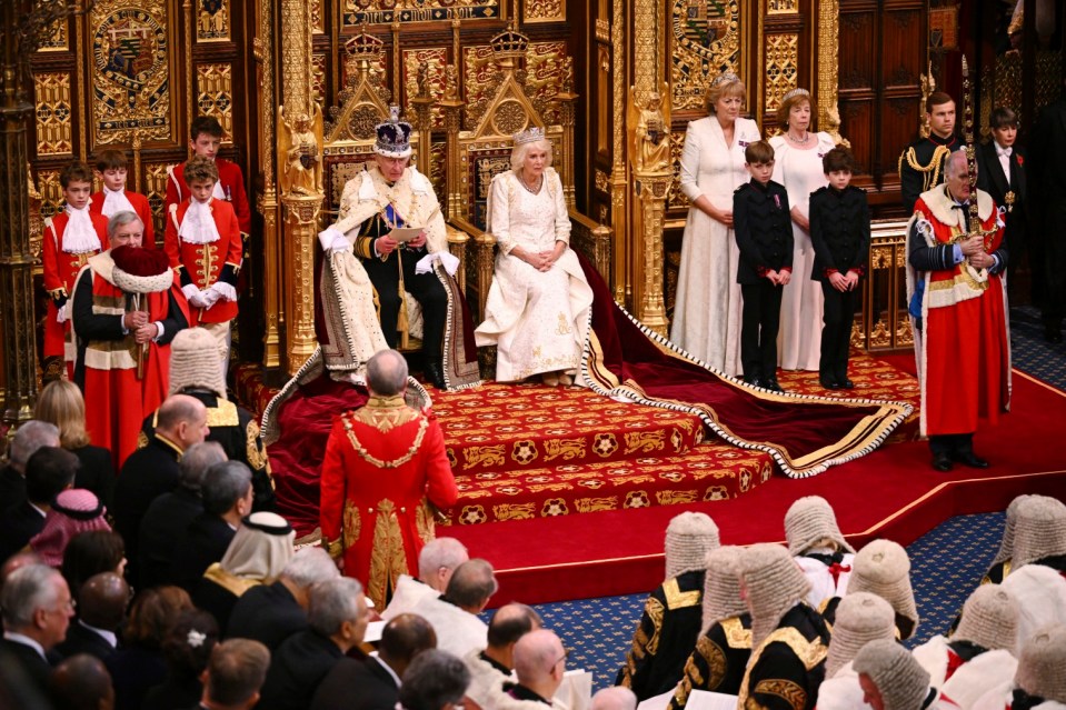 King Charles III, sat next to Queen Camilla, reads out the King's Speech during the State Opening of Parliament in 2023