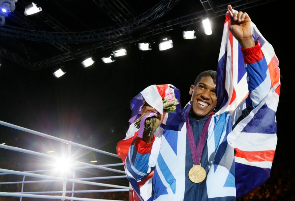 TOPSHOT - Anthony Joshua of Great Britain celebrates during the awards ceremony for the Super-Heavyweight (+91kg) boxing category of the 2012 London Olympic Games at the ExCel Arena August 12, 2012 in London.   AFP PHOTO / Jack GUEZ (Photo by Jack GUEZ / AFP) (Photo by JACK GUEZ/AFP via Getty Images)