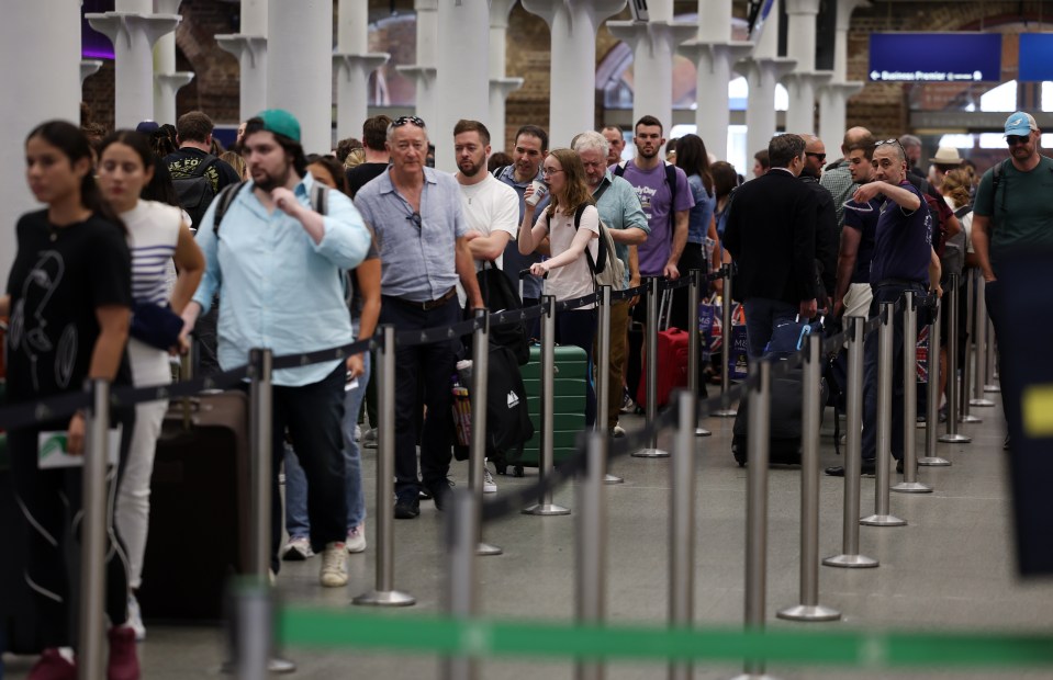 Travellers queue up at the Eurostar rail terminal at St. Pancras International station in London