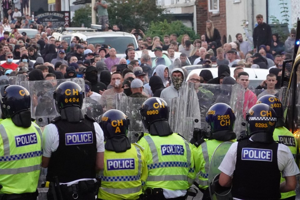 Rows of police face off against the large crowds of protestors