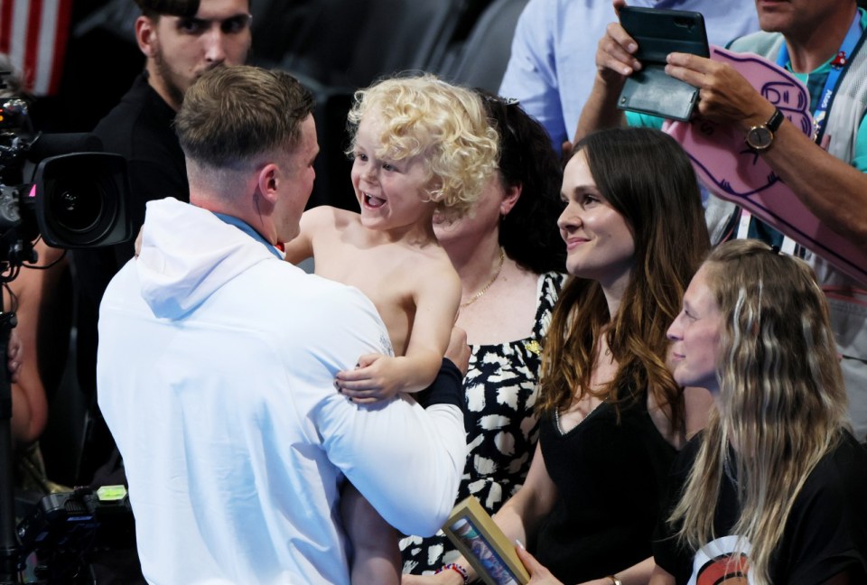 NANTERRE, FRANCE - JULY 28: Adam Peaty of Team Great Britain celebrates with his child and Holly Ramsay, Partner of Adam Peaty, following the Swimming medal ceremony after the Mens 100m Breaststroke Final on day two of the Olympic Games Paris 2024 at Paris La Defense Arena on July 28, 2024 in Nanterre, France. (Photo by Clive Rose/Getty Images) *** BESTPIX ***