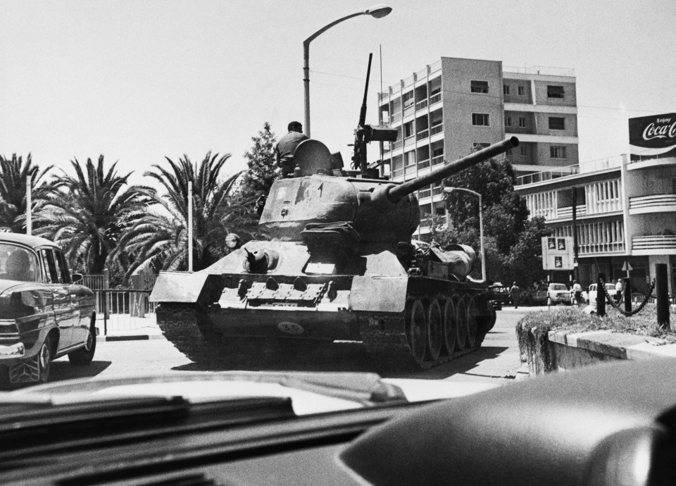 A Greek tank maneuvers in a streets on July 22, 1974 in Nicosia, following Turkey's invasion of Cyprus. After a coup d'état organized by Greek Cypriots, Turkey invaded the northern part of the island of Cyprus on July 20, 1974. After the summer of 1974, The United Nations Force Responsible for Maintaining the Peace in Cyprus (UNFICYP ) established and controlled a demilitarized buffer zone around the Green Line. This conflict precipitated the end of the regime of the colonels in Greece and led to the proclamation, in February 1975, by the Turkish Cypriots, of the creation of their own state chaired by Rauf Denktash, which was however not recognized by the international community. (Photo by Xavier BARON / AFP) (Photo by XAVIER BARON/AFP via Getty Images)