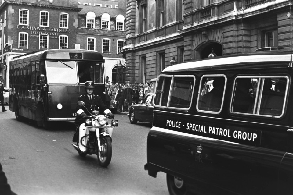 A police coach leaving the court with Reggie Kray, after he was accused of murdering Frank Mitchell