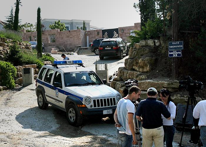 a group of people standing around a jeep that says police on it