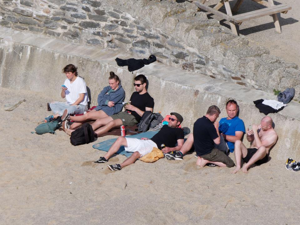 Sun revellers soaking up the raise in Newquay, Cornwall