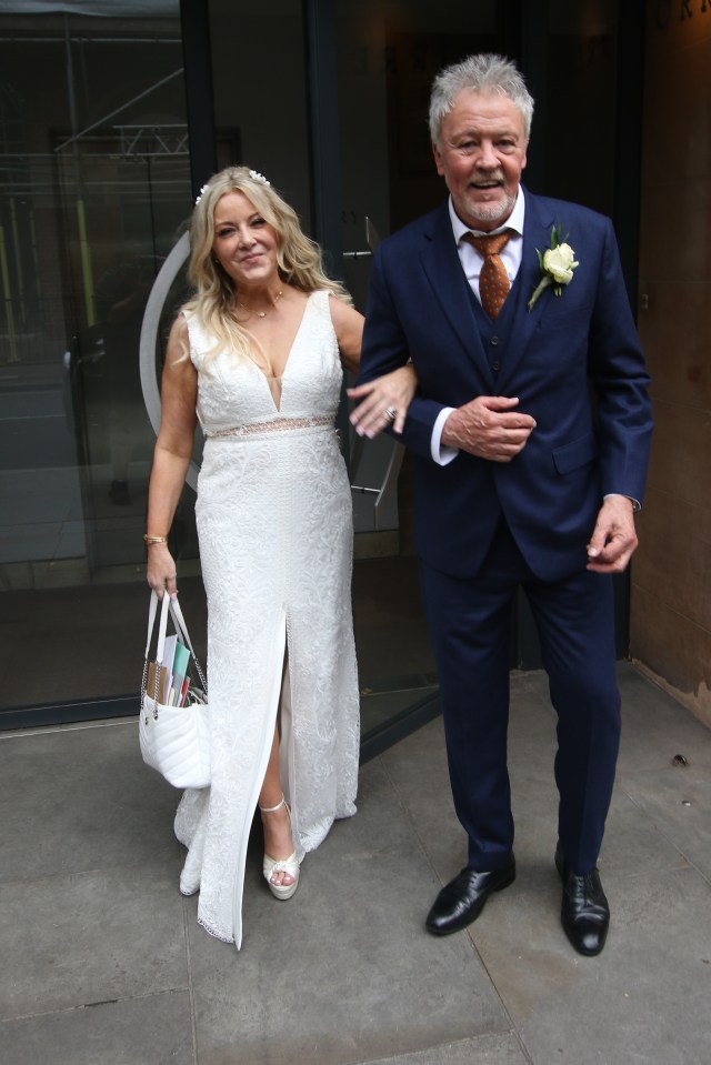 The new bride and groom posed for photos outside the venue