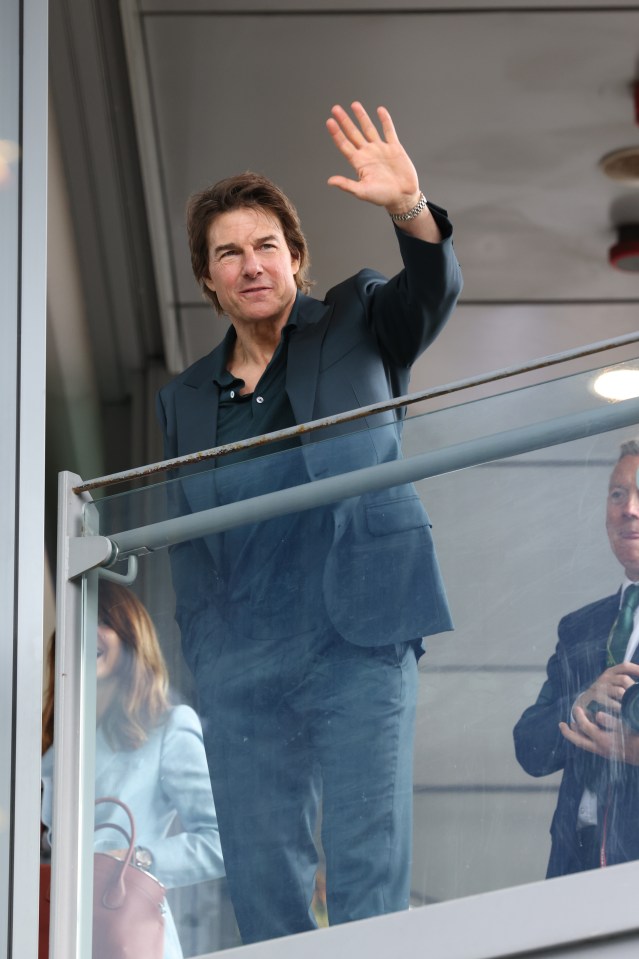 Tom Cruise waved to fans from the hospitality section