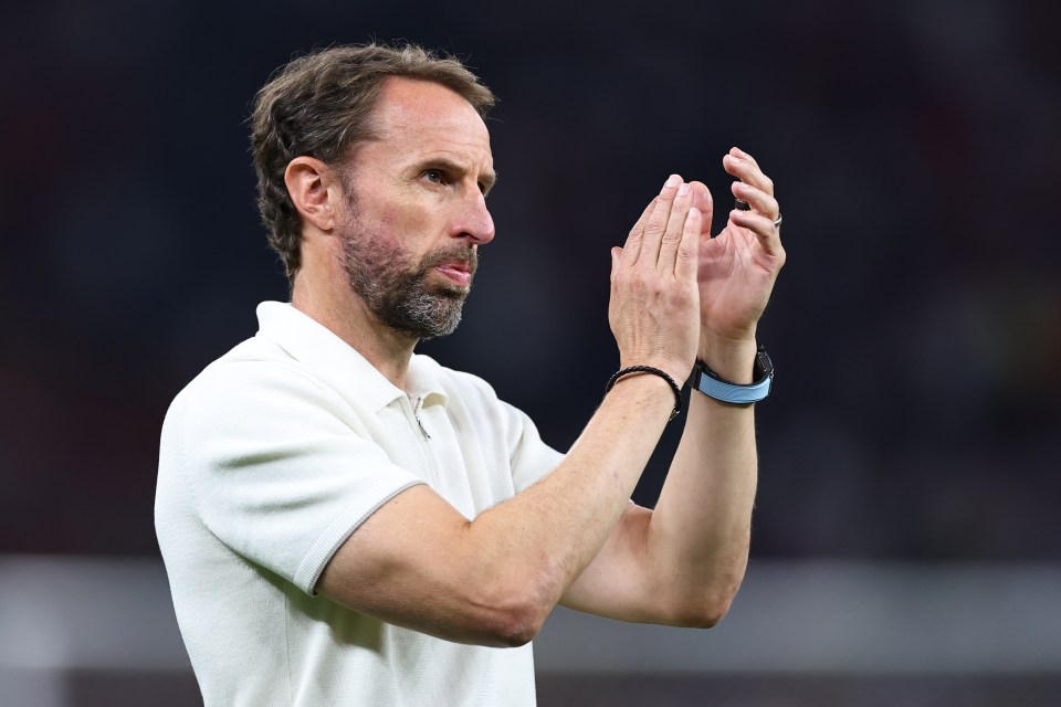 a man in a white shirt is clapping his hands