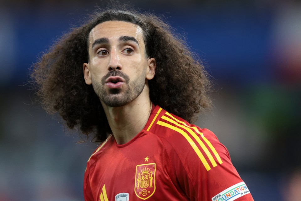 a man with curly hair and a beard wears a red and yellow jersey with the word foundation on it