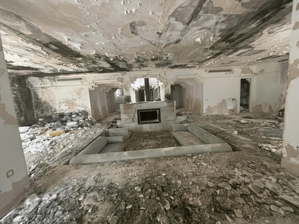 a living room with a fireplace and a couch in the middle