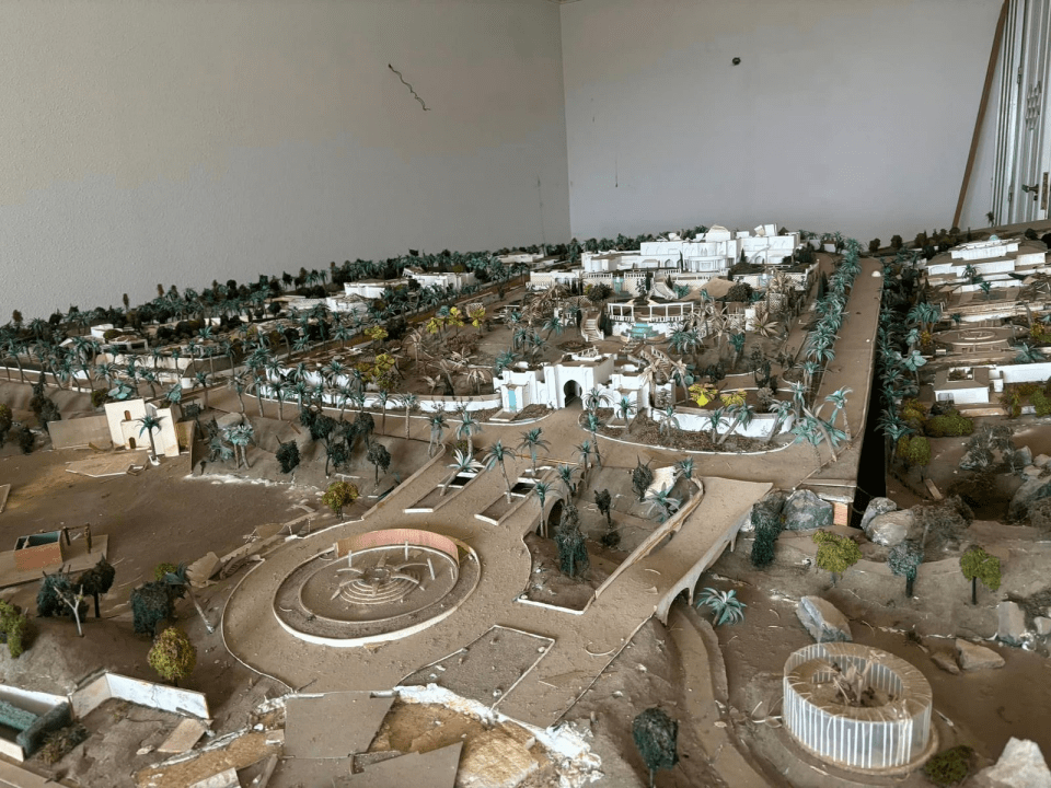 a model of a city with palm trees and buildings