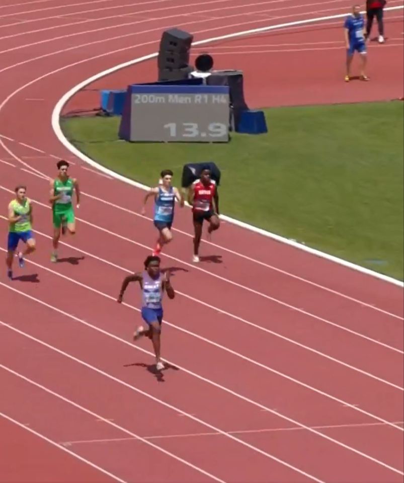 athletes running on a track with a sign that says 13.9