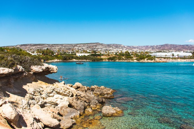 a body of water with a city in the background