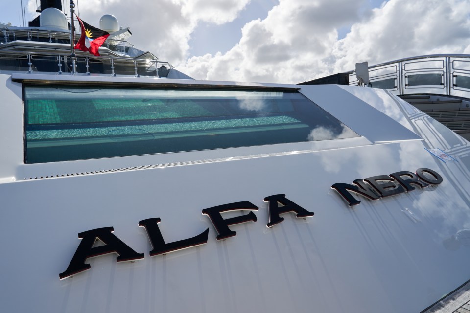 The exterior of the superyacht Alfa Nero docked in a harbour in the Caribbean