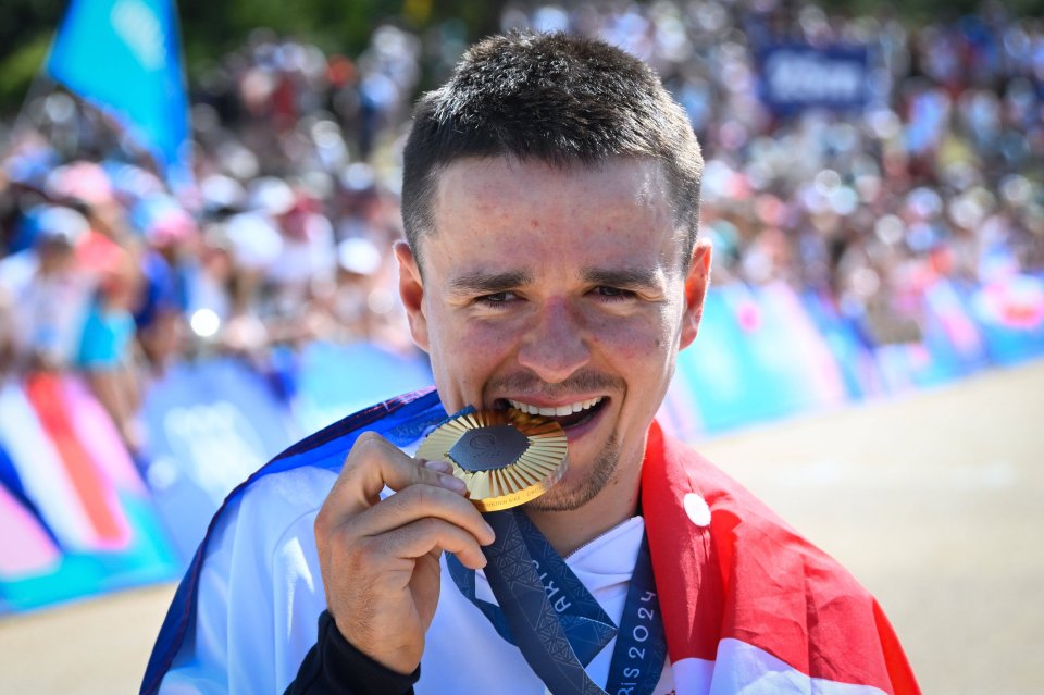 a man with a medal around his neck that says ' sydney ' on it