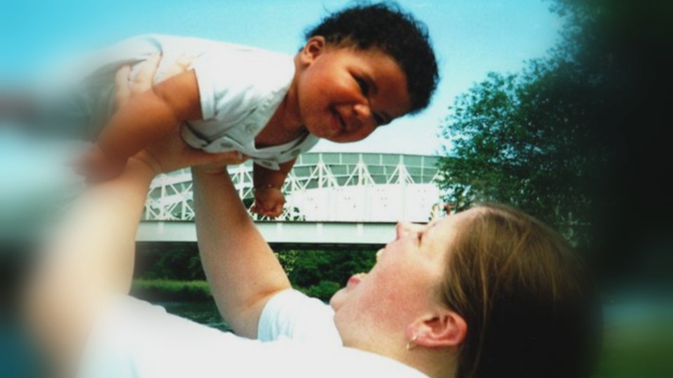 Mum Donna Lee throwing son Kyron into the air as a child