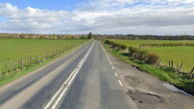 a road with a fence on the side of it