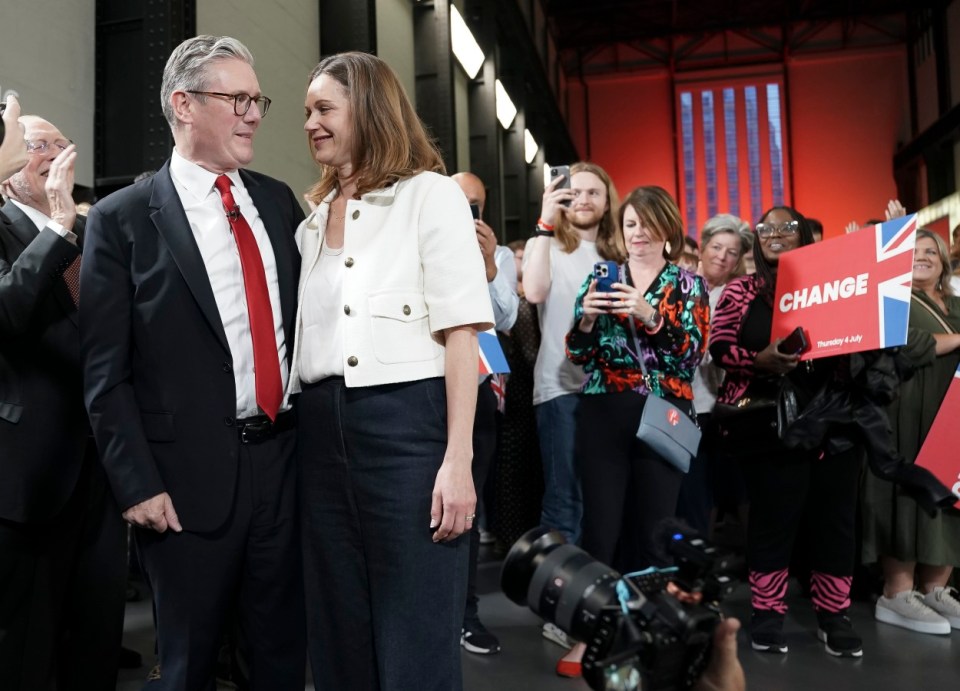 Sir Keir Starmer and wife Lady Victoria Starmer hug after the Labour chief swooped to victory