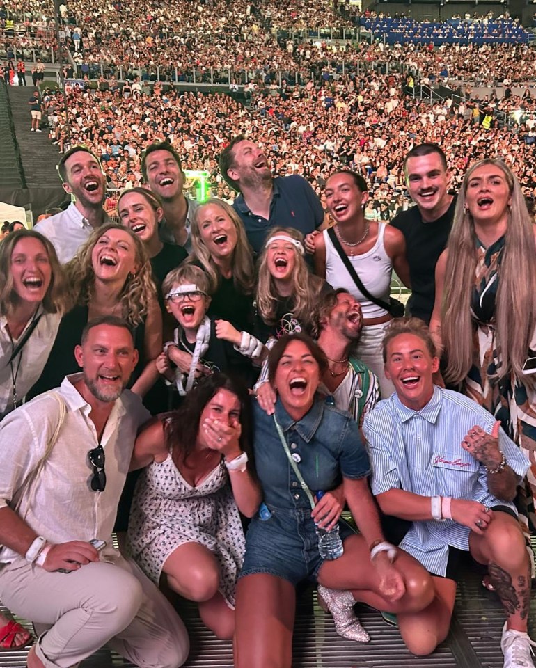 Davina posed with a giant group of pals inside the stadium