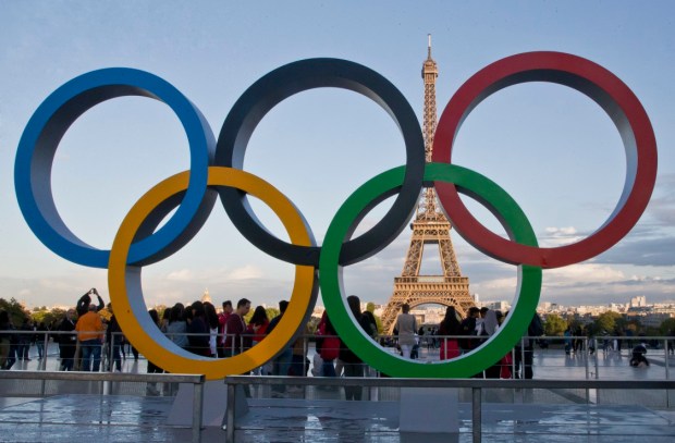 FILE - Olympic rings are set up at Trocadero plaza that overlooks the Eiffel Tower, a day after the official announcement that the 2024 Summer Olympic Games will be in the French capital, in Paris, France, Thursday, Sept. 14, 2017. The World Aquatics governing body published criteria Monday, Sept. 4, 2023, for Russian and Belarusian athletes, coaches and officials to return to try to qualify for the 2024 Paris Olympics as approved neutral athletes during their countries' war on Ukraine. (AP Photo/Michel Euler, File)