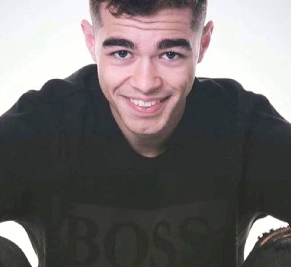 a young man wearing a black shirt with the word boss on it