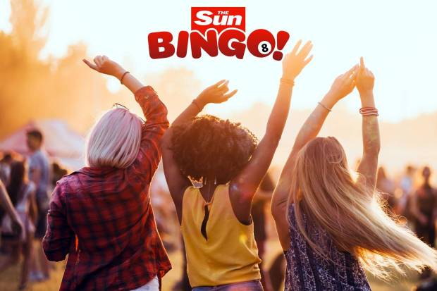 three women are dancing in front of a sun bingo sign