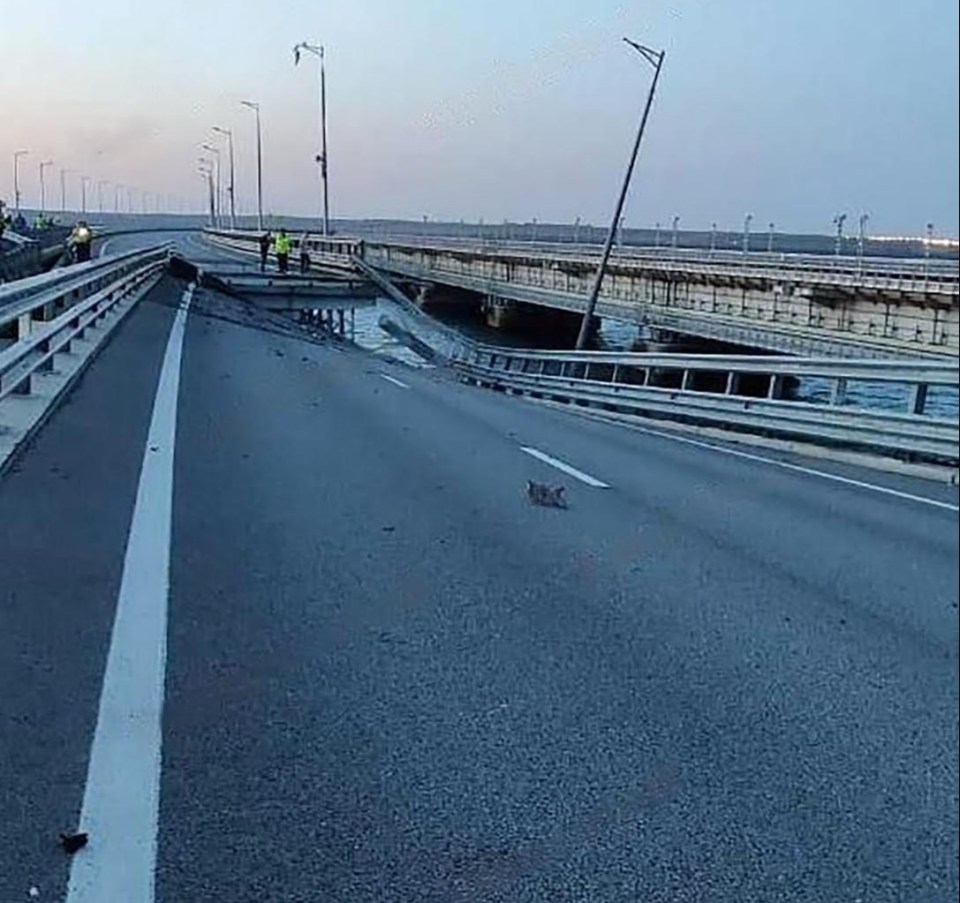 a bridge that has fallen into the water on a highway .