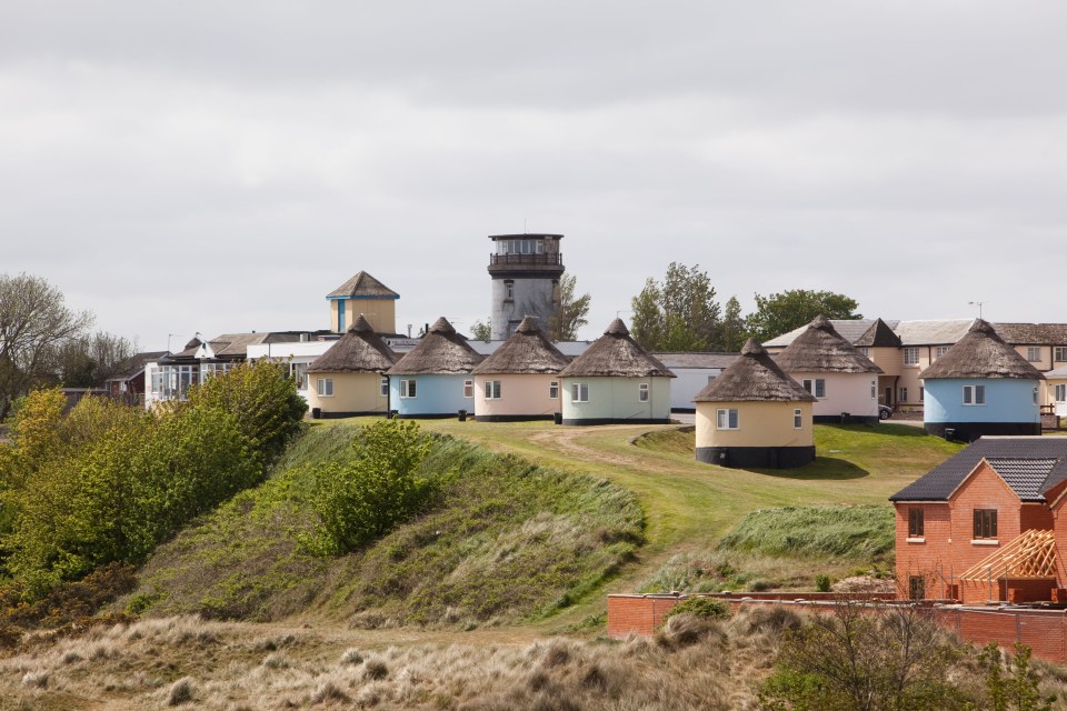 The colourful cottages overlook the beach