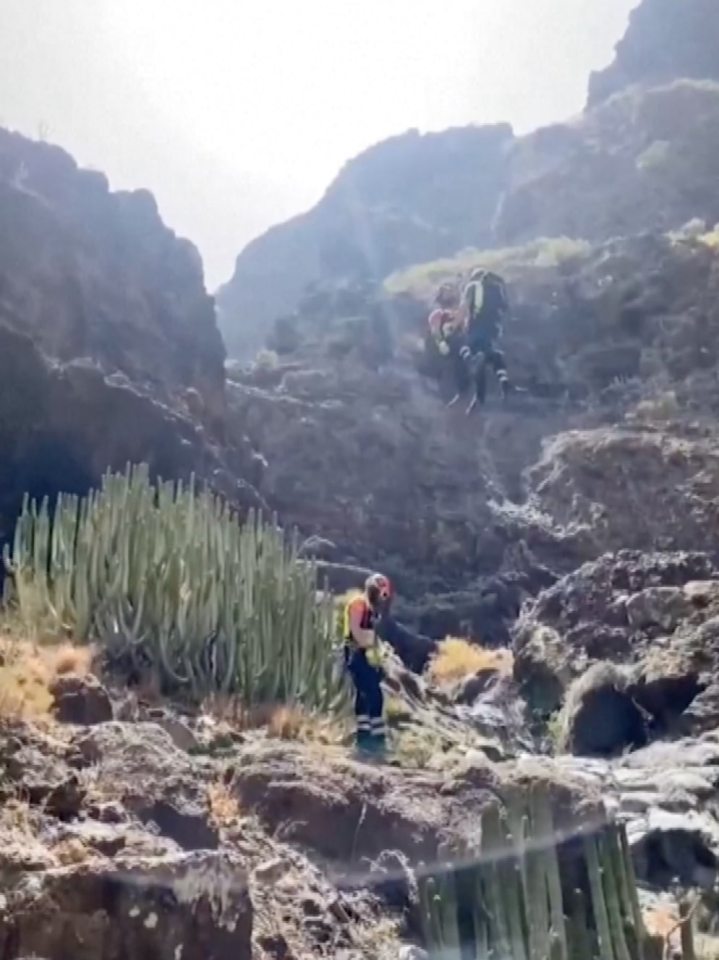 a group of people are hiking up a mountain .