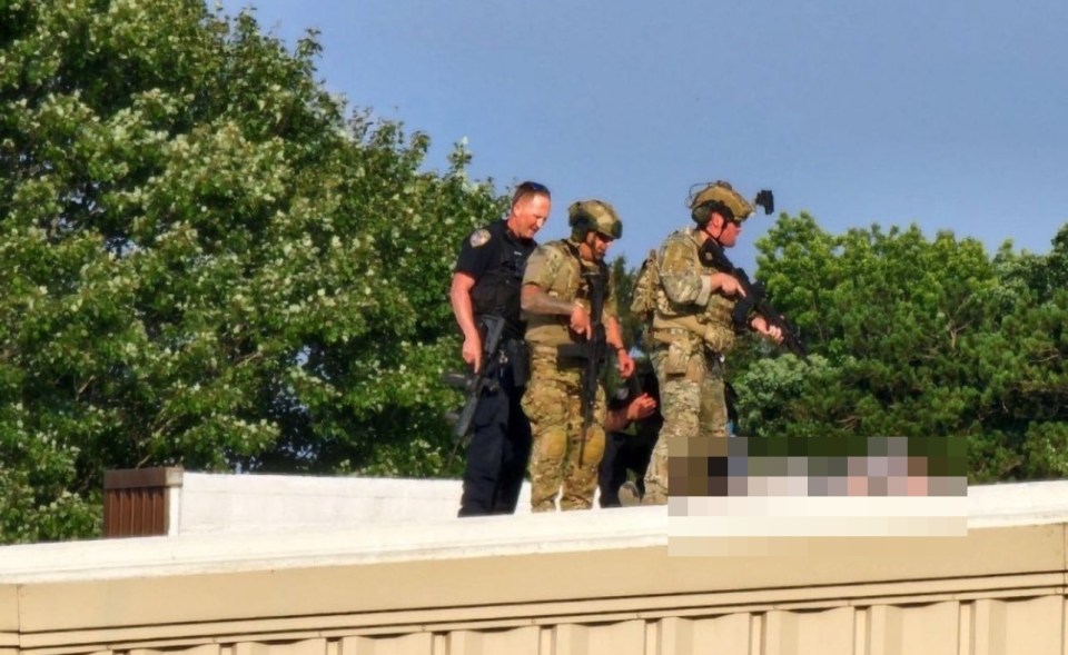 a group of soldiers and a police officer standing on a roof