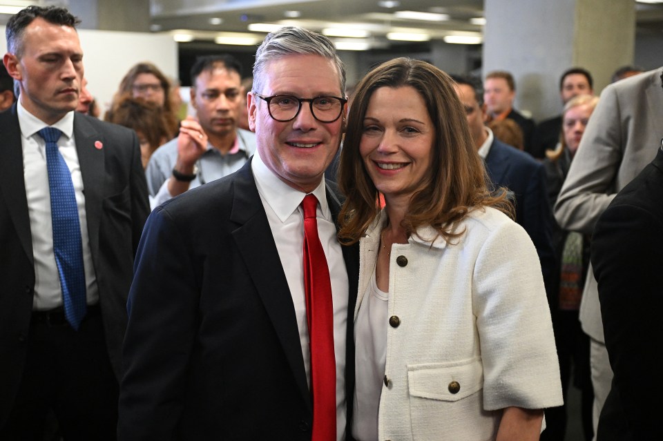 The Labour leader and his wife Victoria pose as he wins his seat